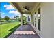 View of the patio leading to a manicured lawn and golf course at 8150 Prestbury Dr, Orlando, FL 32832