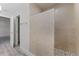 Bathroom featuring a walk-in shower with stone floor, and a hallway leading to a bedroom at 831 Islander Ave, Orlando, FL 32825