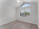 Bright bedroom featuring wood floors, high ceilings, and a large window for natural light at 831 Islander Ave, Orlando, FL 32825