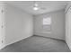 Cozy bedroom featuring neutral walls, a ceiling fan, neutral carpeting, and natural light at 831 Islander Ave, Orlando, FL 32825