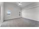 Bright bedroom with gray carpet, ceiling fan, and natural light from two windows at 831 Islander Ave, Orlando, FL 32825