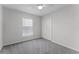 Simple bedroom features a ceiling fan, closet, and neutral walls and carpeting at 831 Islander Ave, Orlando, FL 32825