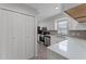 Bright kitchen features white cabinets, stainless steel appliances, and ample counter space at 831 Islander Ave, Orlando, FL 32825