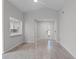 Open-concept living room with wood floors, neutral tones, and view to kitchen and entry at 831 Islander Ave, Orlando, FL 32825