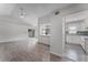 Open-concept living room with wood floors and a view of the eat-in kitchen with a breakfast bar at 831 Islander Ave, Orlando, FL 32825