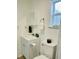 Bathroom with white vanity, decorative decor, and a modern toilet for a simple, updated look at 934 Savannah Ave, Lakeland, FL 33815