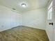 Bedroom featuring wood-look flooring, closet, and a window providing natural light at 934 Savannah Ave, Lakeland, FL 33815