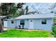 Charming single-story home with a metal roof, fresh blue paint, and inviting front yard at 934 Savannah Ave, Lakeland, FL 33815