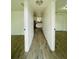 Hallway view showcasing wood-look flooring and access to the kitchen and living area at 934 Savannah Ave, Lakeland, FL 33815