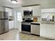 Modern kitchen featuring white cabinets, stainless steel appliances, and stylish countertops at 934 Savannah Ave, Lakeland, FL 33815