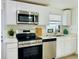 Updated kitchen with white cabinetry, stainless steel appliances, and modern countertops at 934 Savannah Ave, Lakeland, FL 33815