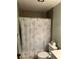 The bathroom has a shower with a shower curtain, toilet and tile walls at 5964 Peregrine Ave # C02, Orlando, FL 32819