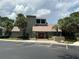 A beautiful clubhouse surrounded by lush landscaping and ample parking at 5964 Peregrine Ave # C02, Orlando, FL 32819