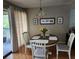 Cozy dining area with hardwood floors, room for four, and natural light at 5964 Peregrine Ave # C02, Orlando, FL 32819