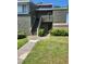 Charming two-story condo with lush green lawn, exterior staircase, and nice landscaping at 5964 Peregrine Ave # C02, Orlando, FL 32819