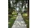 Tranquil setting with mature trees and grassy area with a paved path to the condos at 5964 Peregrine Ave # C02, Orlando, FL 32819