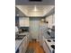 Cozy kitchen featuring stainless steel sink, white appliances, and wood flooring at 5964 Peregrine Ave # C02, Orlando, FL 32819