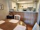 Charming kitchen with a view to the dining area, white appliances and laminate countertops at 5964 Peregrine Ave # C02, Orlando, FL 32819