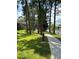 Scenic view of pond and walkway with lush green spaces and mature trees at 5964 Peregrine Ave # C02, Orlando, FL 32819