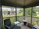 Screened-in porch with seating and views of neighboring condos and lush landscaping at 5964 Peregrine Ave # C02, Orlando, FL 32819