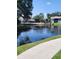 Serene view of the lake, bridge and building which invites relaxation at 5964 Peregrine Ave # C02, Orlando, FL 32819