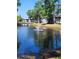 Beautiful water view of townhomes with lush trees and a scenic fountain at 5964 Peregrine Ave # C02, Orlando, FL 32819