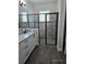 Bathroom with glass shower door, granite counter tops, and white cabinets at 0 Overton St, Orlando, FL 32833