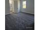 Bedroom with gray carpet, light gray walls, and a walk way to bathroom at 0 Overton St, Orlando, FL 32833