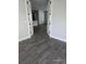 Open floor plan showcasing wood-look tile flooring and freshly painted light-gray walls at 0 Overton St, Orlando, FL 32833