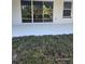 Rear patio featuring a painted concrete surface and a glimpse of the landscaped backyard at 0 Overton St, Orlando, FL 32833