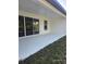 Covered patio with a neutral painted surface and views of the green backyard at 0 Overton St, Orlando, FL 32833