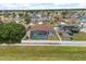 Aerial view of the home with screened-in pool and fenced yard in a residential neighborhood at 10 Alicante Ct, Kissimmee, FL 34758