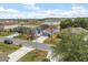 A light-blue house is surrounded by a yard with palm trees and is near a body of water with other residential areas at 10 Alicante Ct, Kissimmee, FL 34758