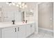 Bathroom features a double sink vanity with white cabinets, and large mirrors at 10 Alicante Ct, Kissimmee, FL 34758