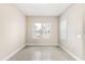 Neutral bedroom offers tile floors, light walls, trim and view of exterior at 10 Alicante Ct, Kissimmee, FL 34758