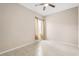 Bedroom with a ceiling fan and window with neutral colored curtains and tile floors at 10 Alicante Ct, Kissimmee, FL 34758