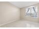 Neutral bedroom with tile flooring and large window with view of neighborhood at 10 Alicante Ct, Kissimmee, FL 34758