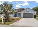 Charming single-story home with a well-manicured front yard and a spacious two-car garage at 10 Alicante Ct, Kissimmee, FL 34758