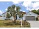 Charming one-story home with a well-manicured lawn, a two-car garage, and a lovely blue exterior at 10 Alicante Ct, Kissimmee, FL 34758