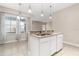 Kitchen island boasts granite countertops and a stainless steel sink, perfect for meal preparation at 10 Alicante Ct, Kissimmee, FL 34758