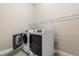 White laundry machines are featured in laundry room with open door at 10 Alicante Ct, Kissimmee, FL 34758