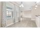 Bright living room featuring tile floors and large windows with views of the pool at 10 Alicante Ct, Kissimmee, FL 34758