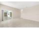 Living room with tiled floor and sliding doors open to a screened-in lanai at 10 Alicante Ct, Kissimmee, FL 34758
