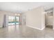 Living room with tiled floor, neutral paint, and sliding glass doors to the pool area at 10 Alicante Ct, Kissimmee, FL 34758