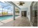 Covered patio with view of pool and sliding glass door into the home at 10 Alicante Ct, Kissimmee, FL 34758