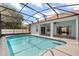 Screened-in pool with covered patio and view of the back of the home at 10 Alicante Ct, Kissimmee, FL 34758