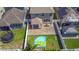 This aerial view shows a backyard with a covered patio, trampoline, inflatable pool, and a fenced yard at 10658 Bannan St, Orlando, FL 32832