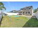 Spacious backyard with lush grass, fenced perimeter, covered patio, and outdoor seating area at 10658 Bannan St, Orlando, FL 32832
