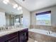 Luxury bathroom features a soaking tub, double vanity, and a separate glass shower at 10658 Bannan St, Orlando, FL 32832