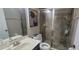 Bathroom featuring tiled shower with glass doors, toilet, and single sink at 10658 Bannan St, Orlando, FL 32832